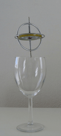 Gyroscope balanced on wine glass